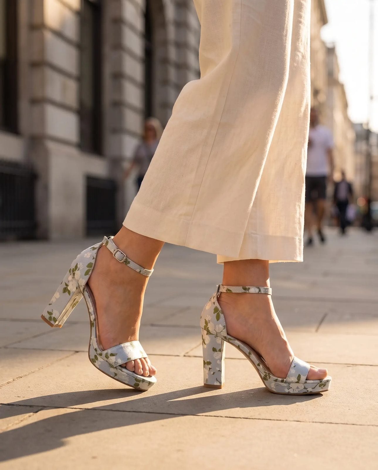 Asia – Blue Floral block-heel sandals worn with cream trousers on a city street